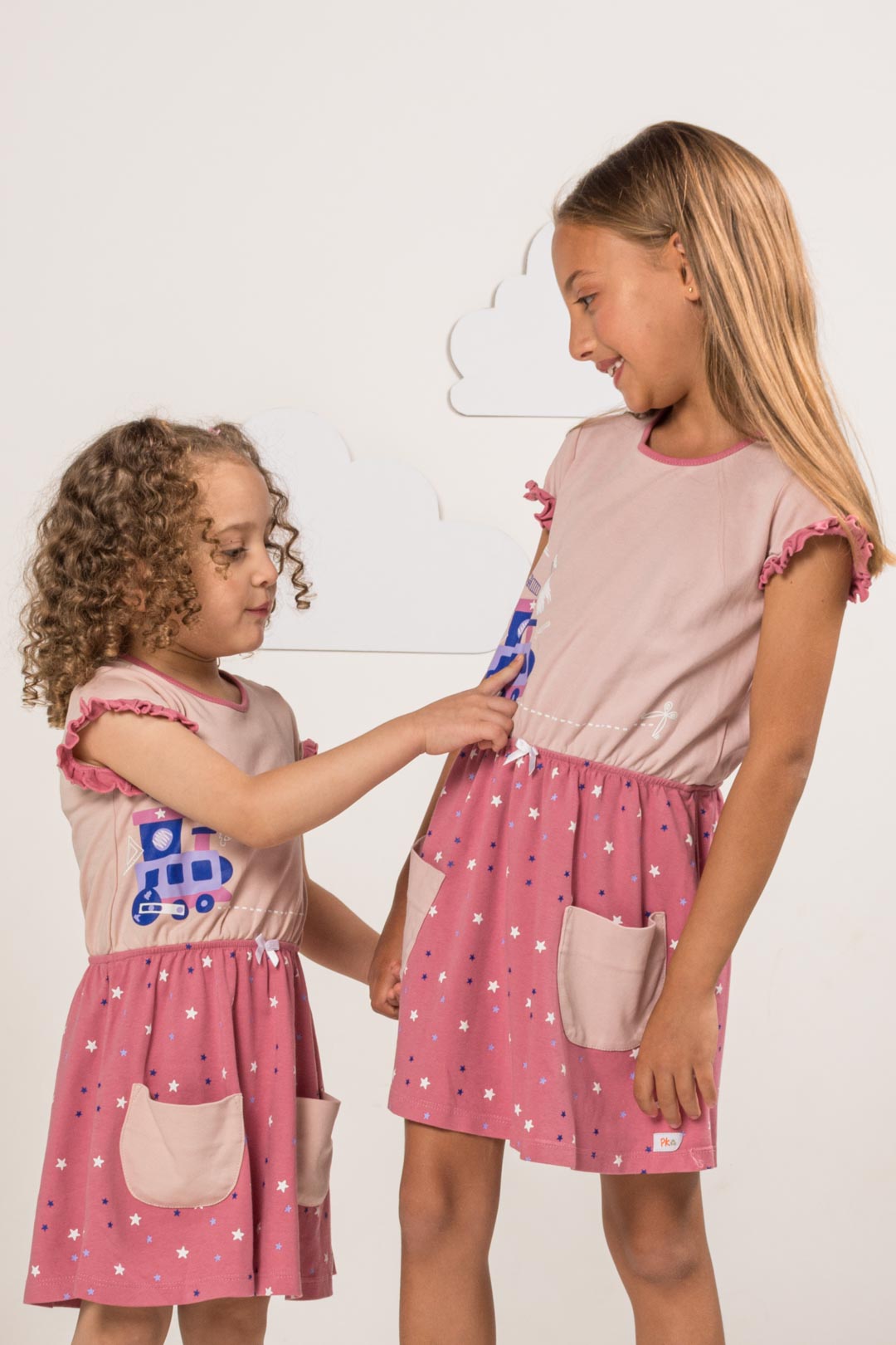Girls wearing pink train dress with pockets by prisma kiddos