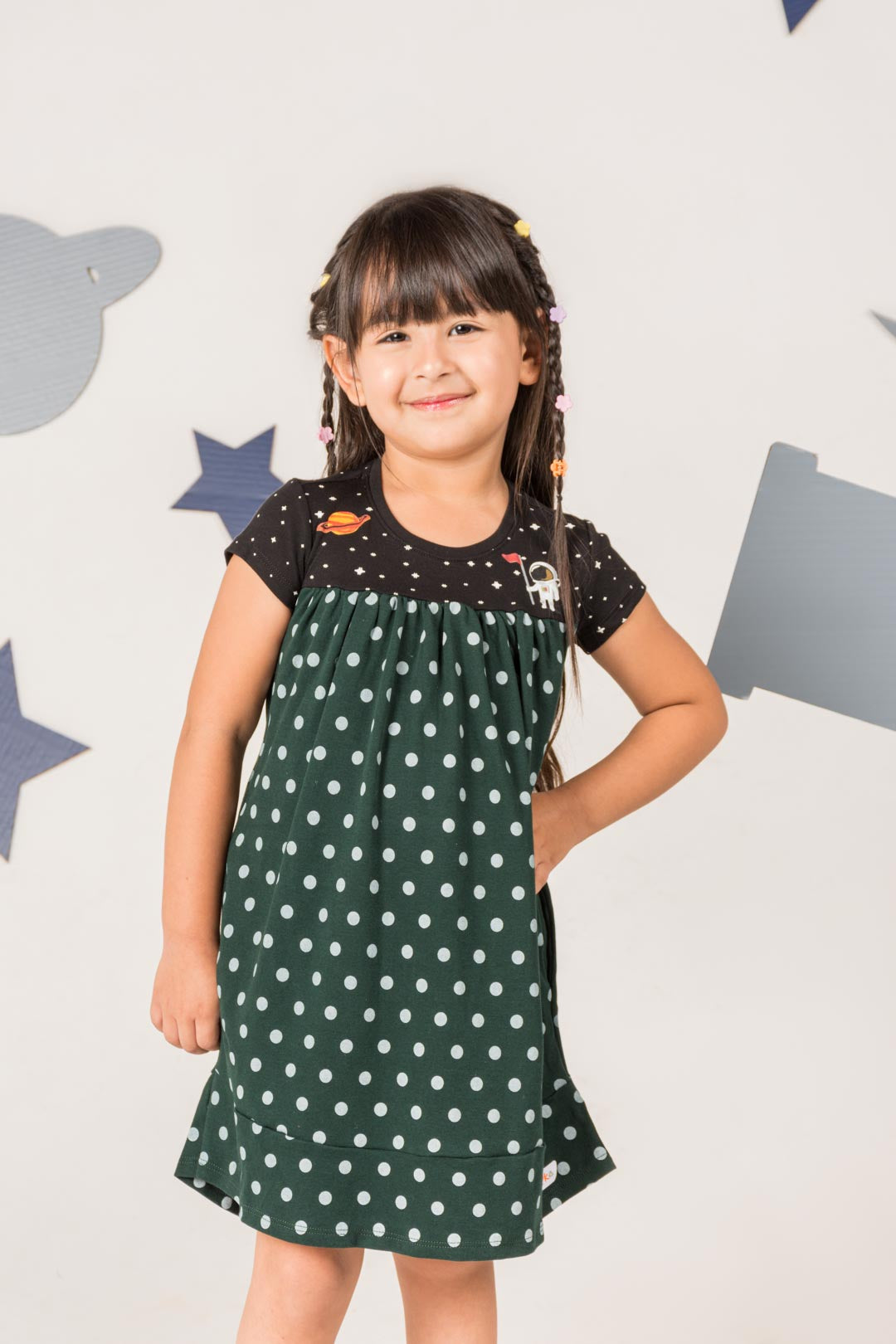 Girls wearing green space dress with pockets by prisma kiddos