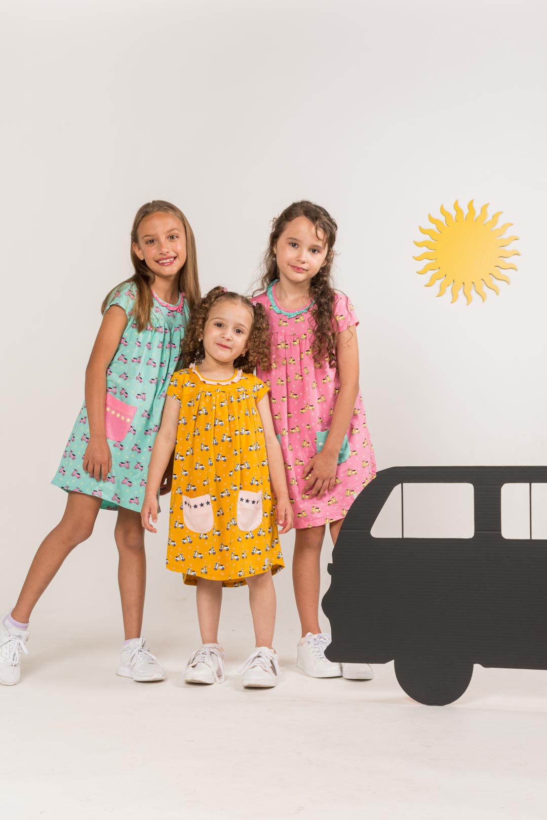 Three girls wearing dresses prismakiddos
