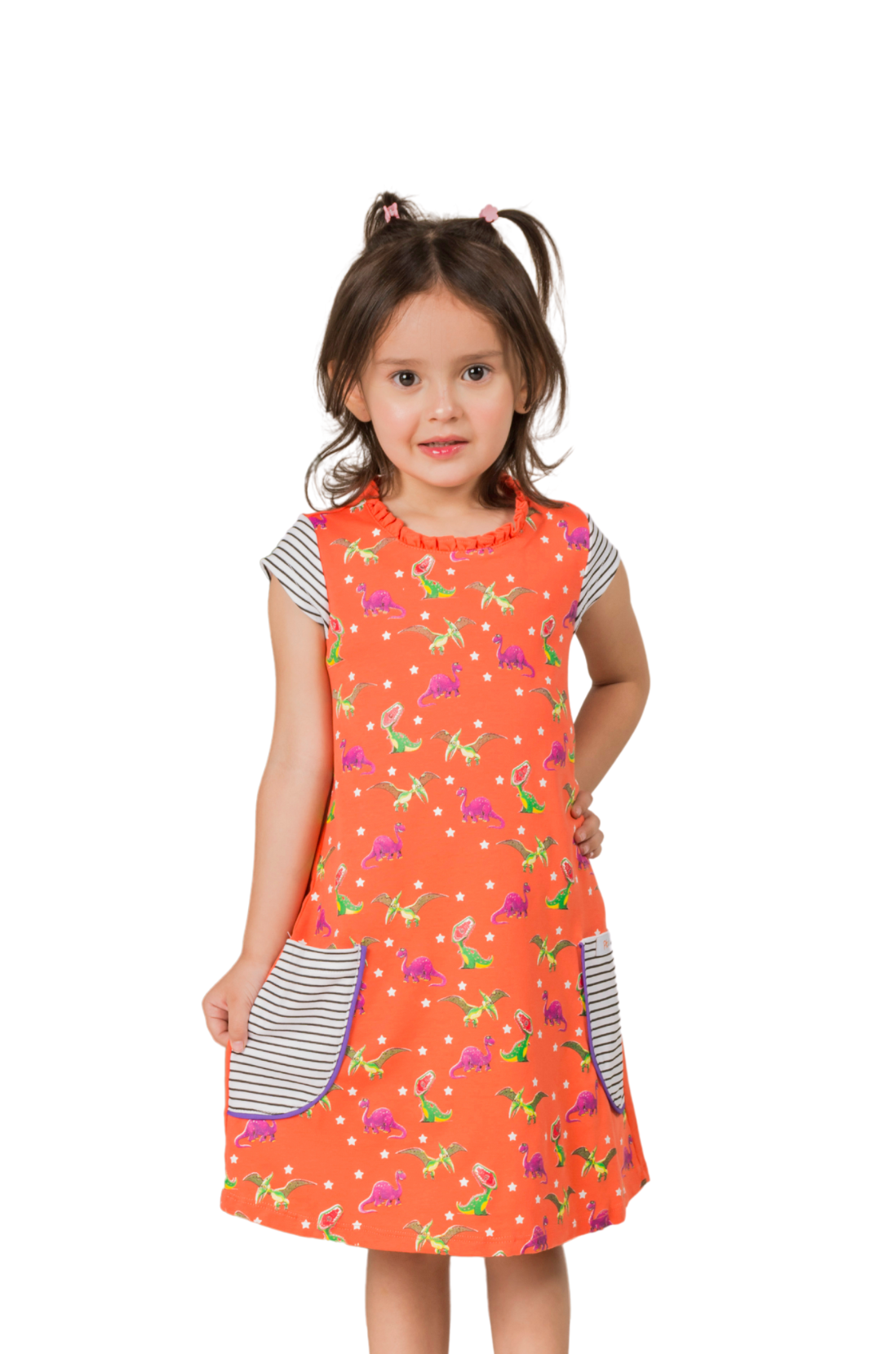 Little girl exploring outdoors in a coral pink short-sleeve dress featuring a fade-resistant T-Rex print and horizontal striped front pockets.