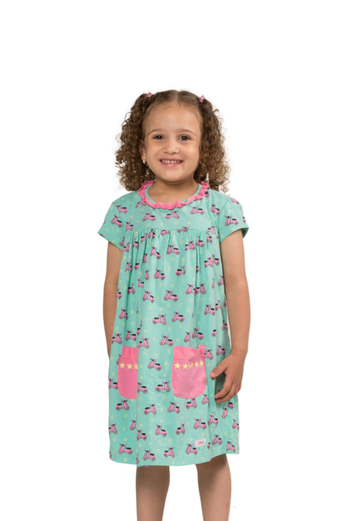 Full length shot of a girl in a fresh mint green empire-style dress with playful scooter and star patterns, short sleeves, and hidden pockets.