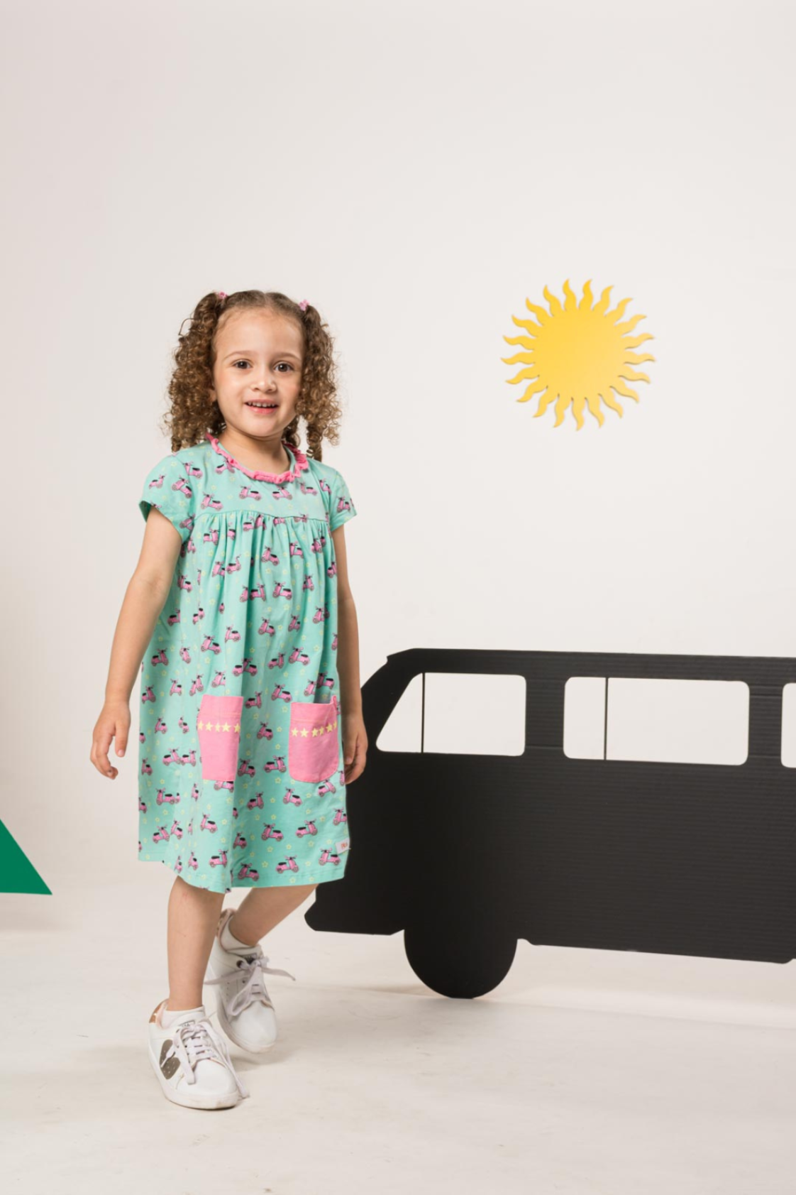 Young girl wearing Vespa Green Dress, and posing with happy expression