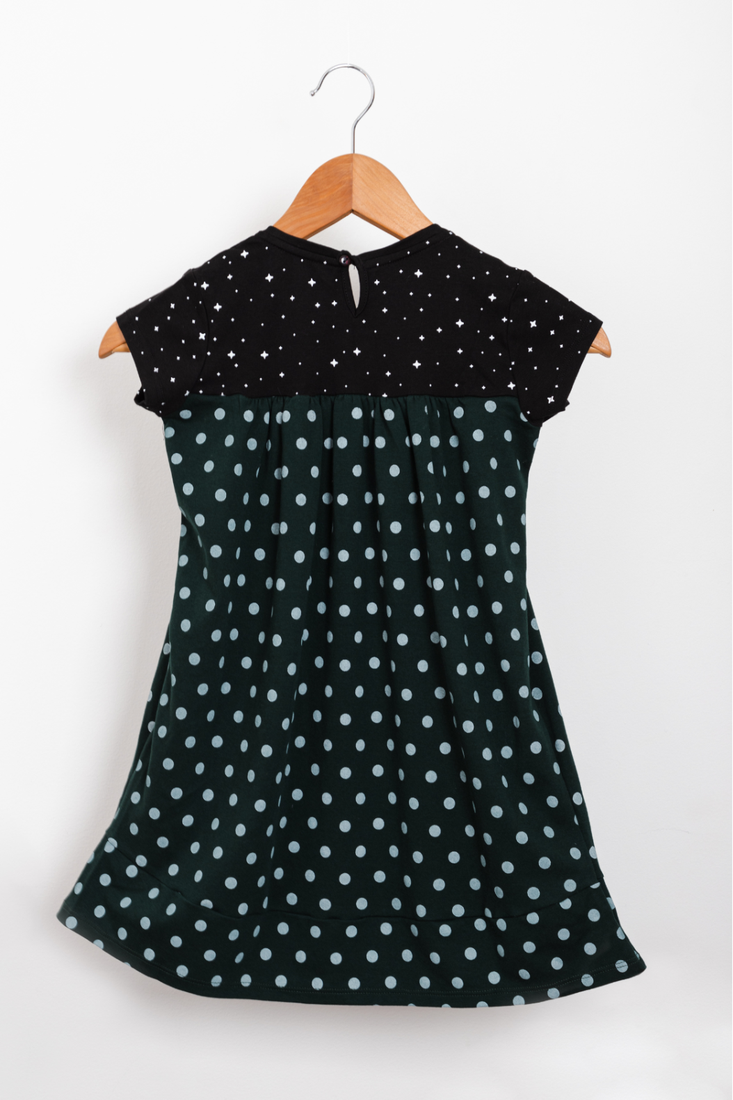 Forest green empire-style dress decorated with astronaut graphics and a constellation-patterned skirt.