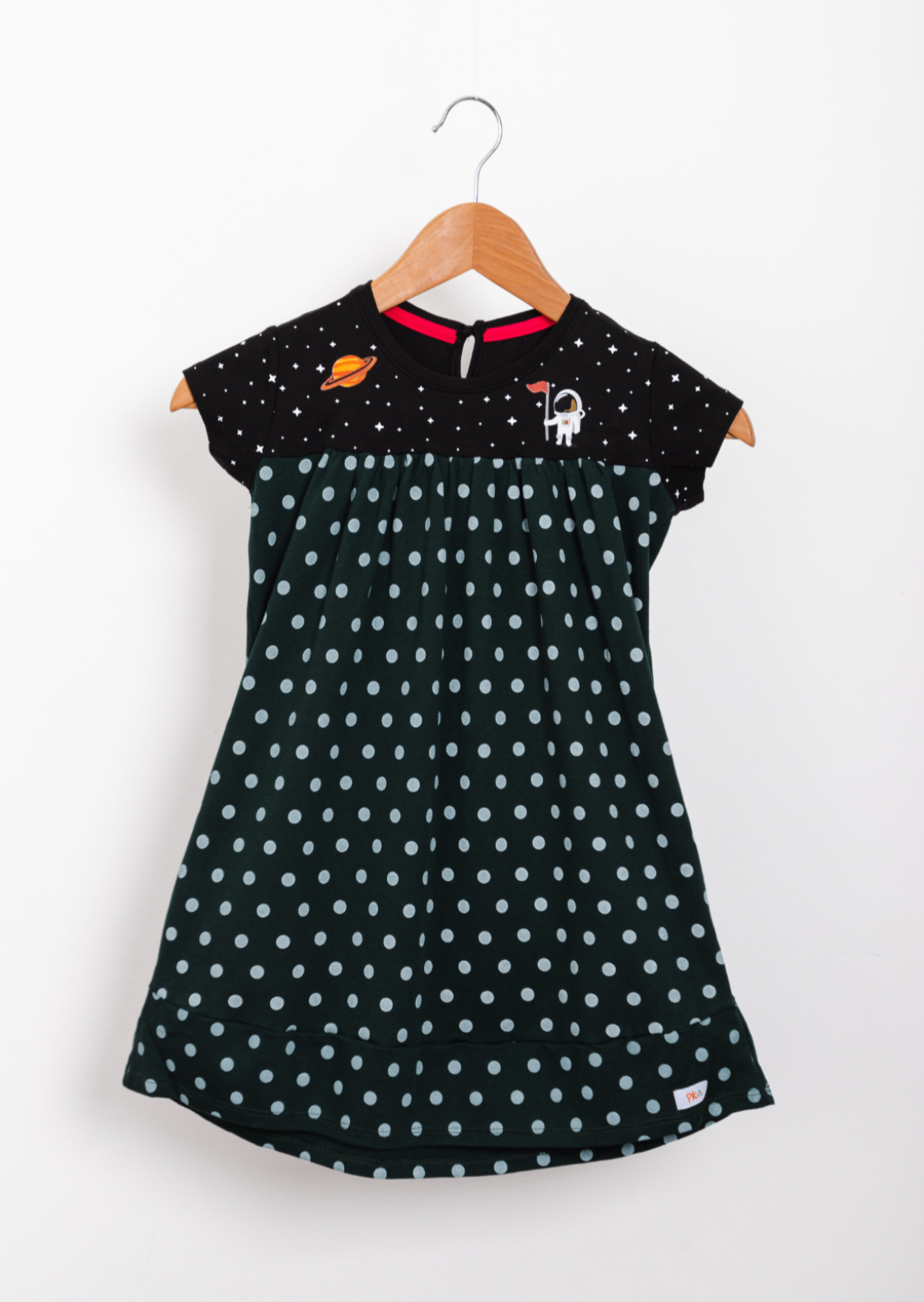Forest green empire-style dress decorated with astronaut graphics and a constellation-patterned skirt.
