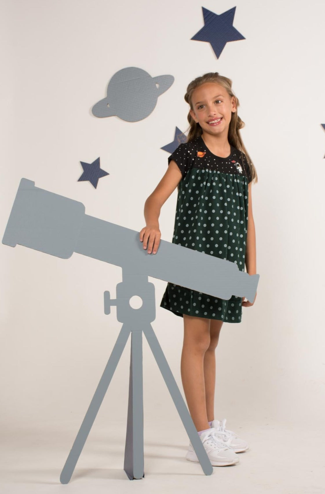 Forest green empire-style dress decorated with astronaut graphics and a constellation-patterned skirt.