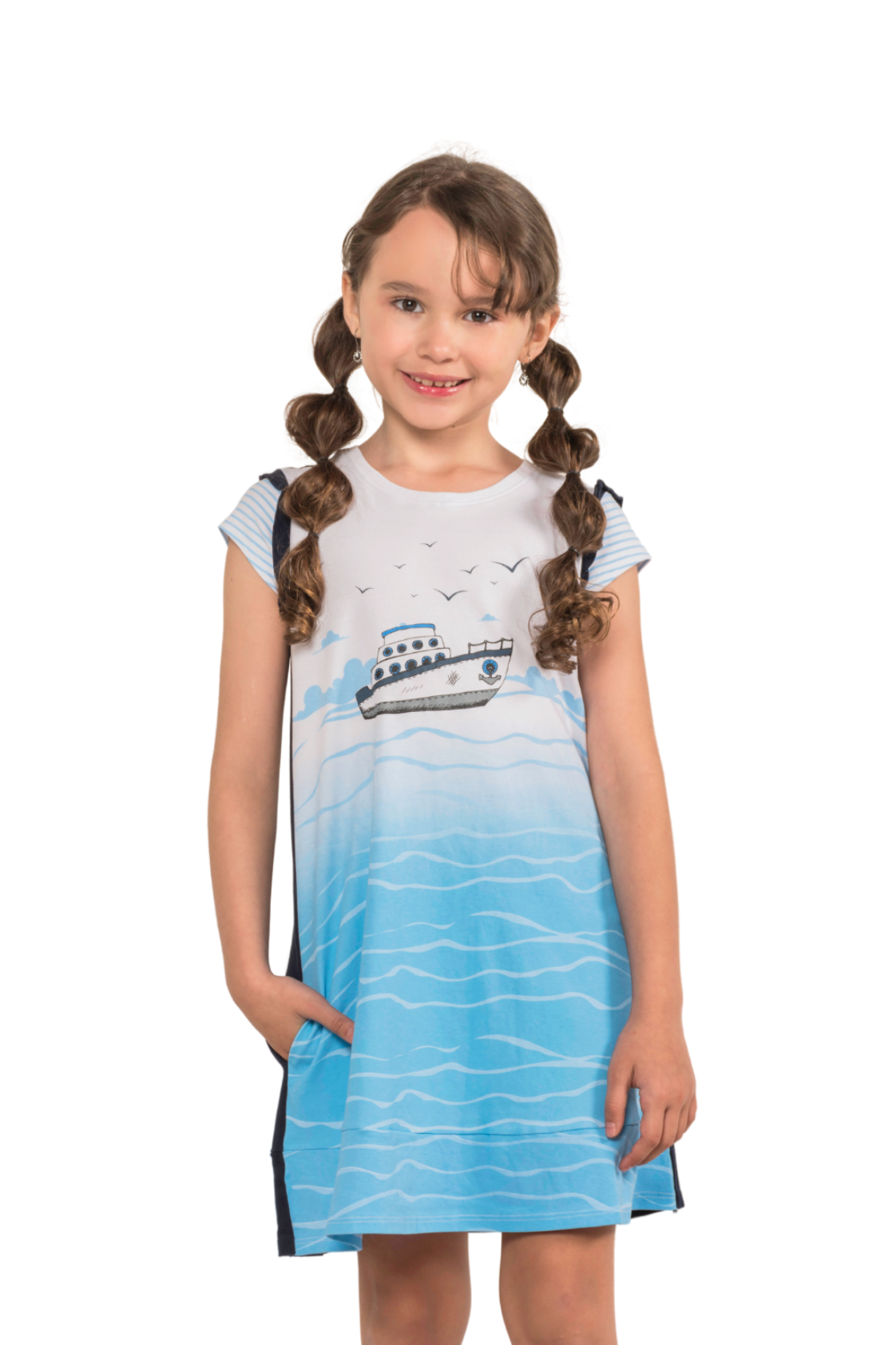Girl wearing a white front, ocean-blue back dress with an illustrated sailboat print, featuring textured ruffle sleeves and side pockets.