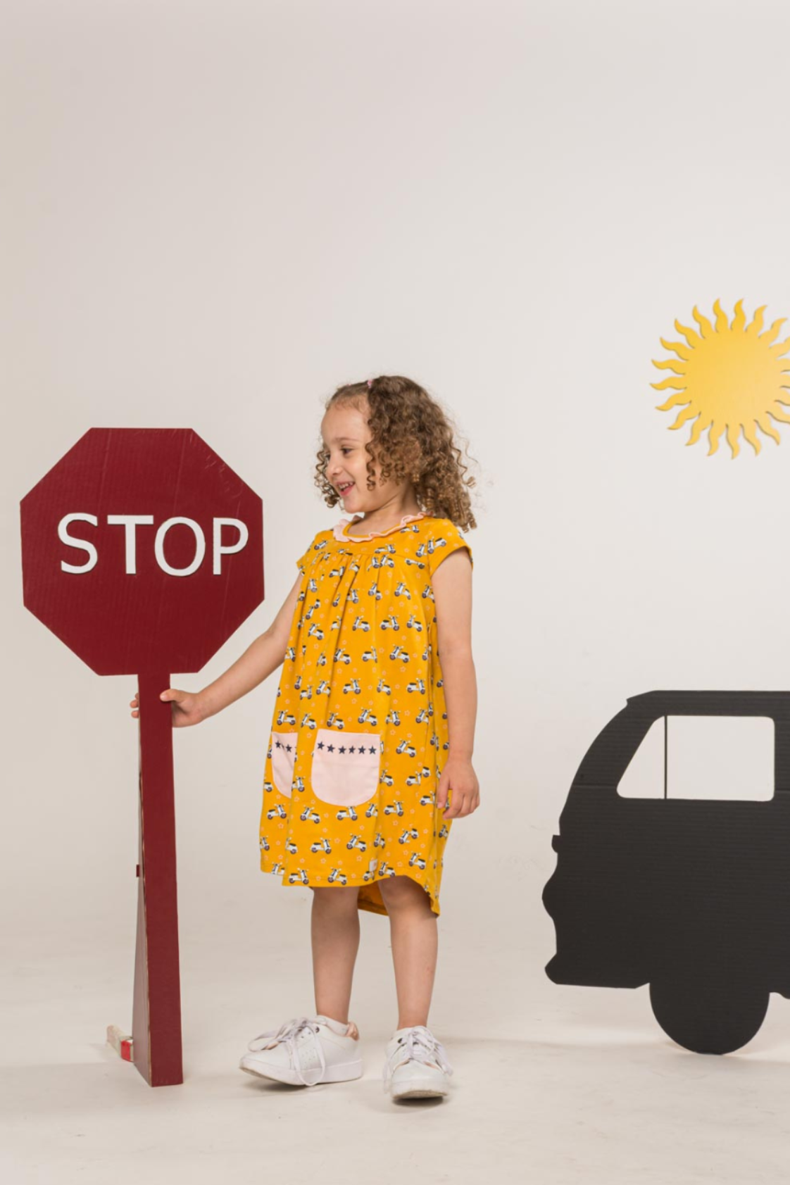 Girl wearing vespa yellow dress.