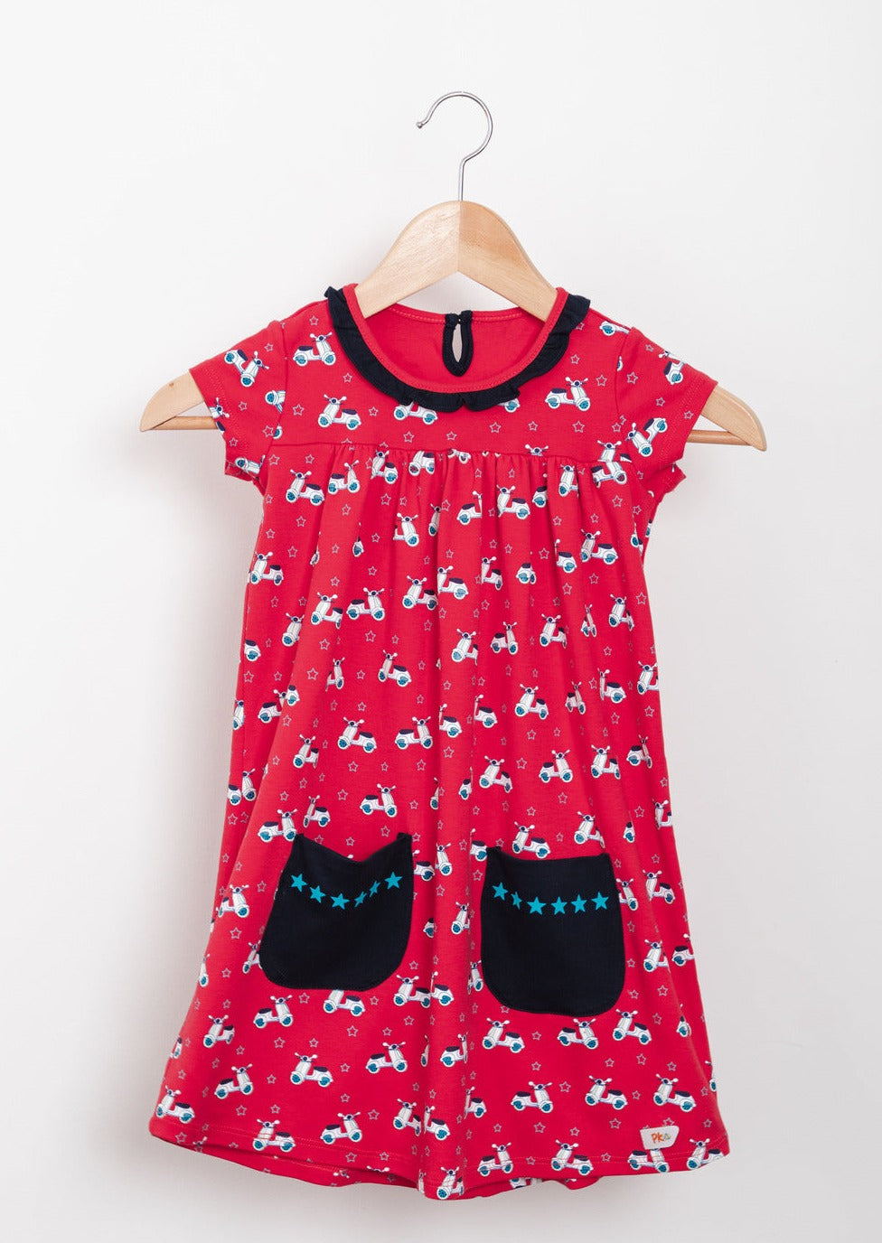 Red scooter-themed empire dresses with star-lined pockets, tailored from premium cotton.